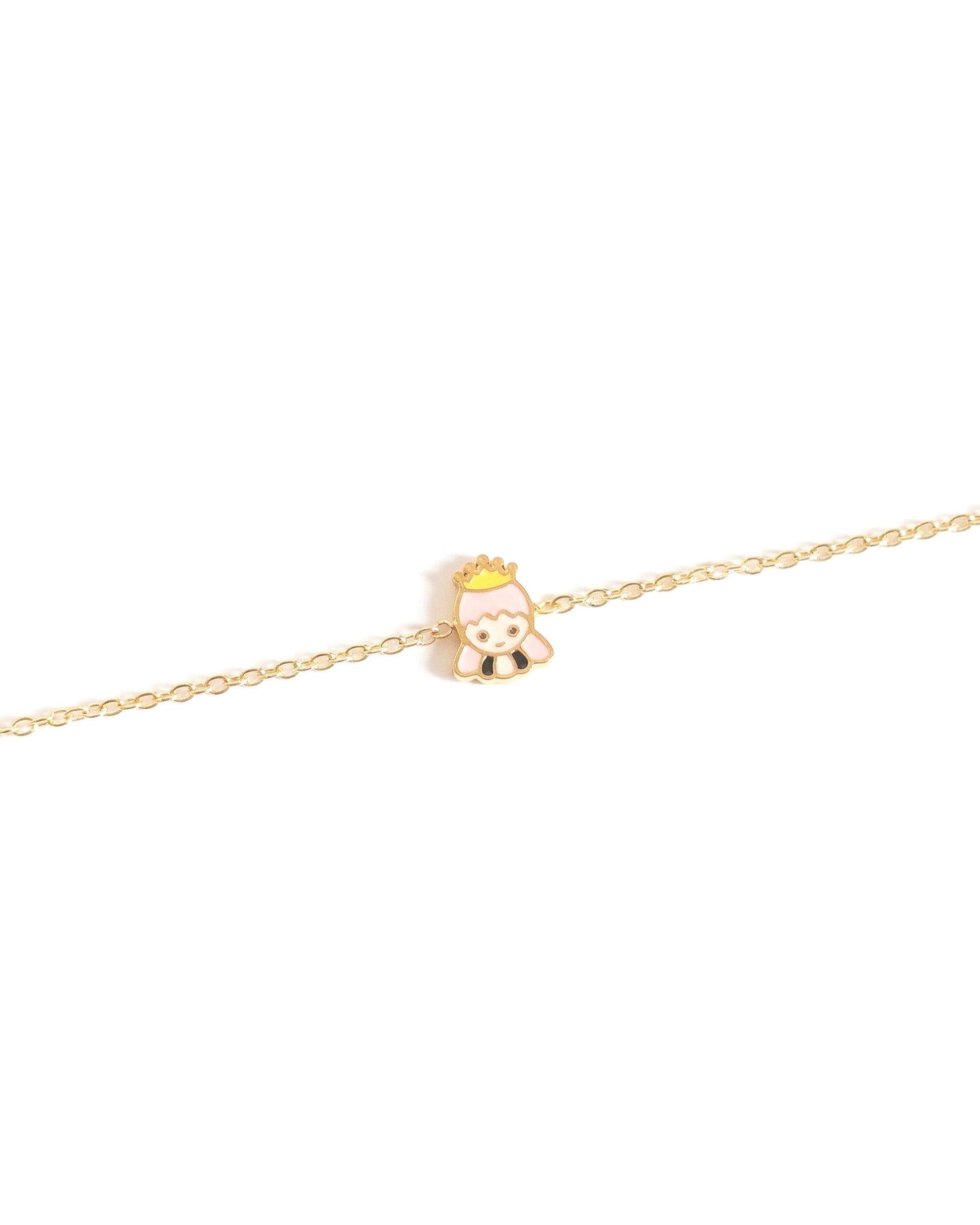 Gold bracelet with a small princess charm on a white background