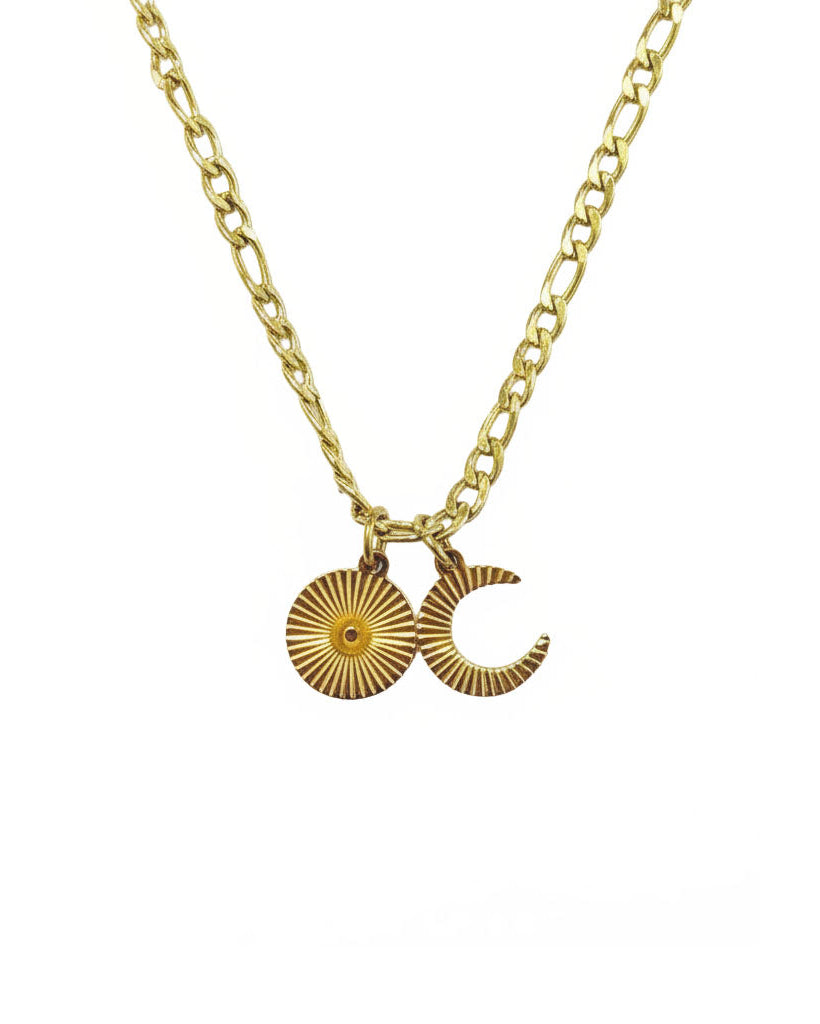 Gold necklace with sun and moon pendants on a white background
